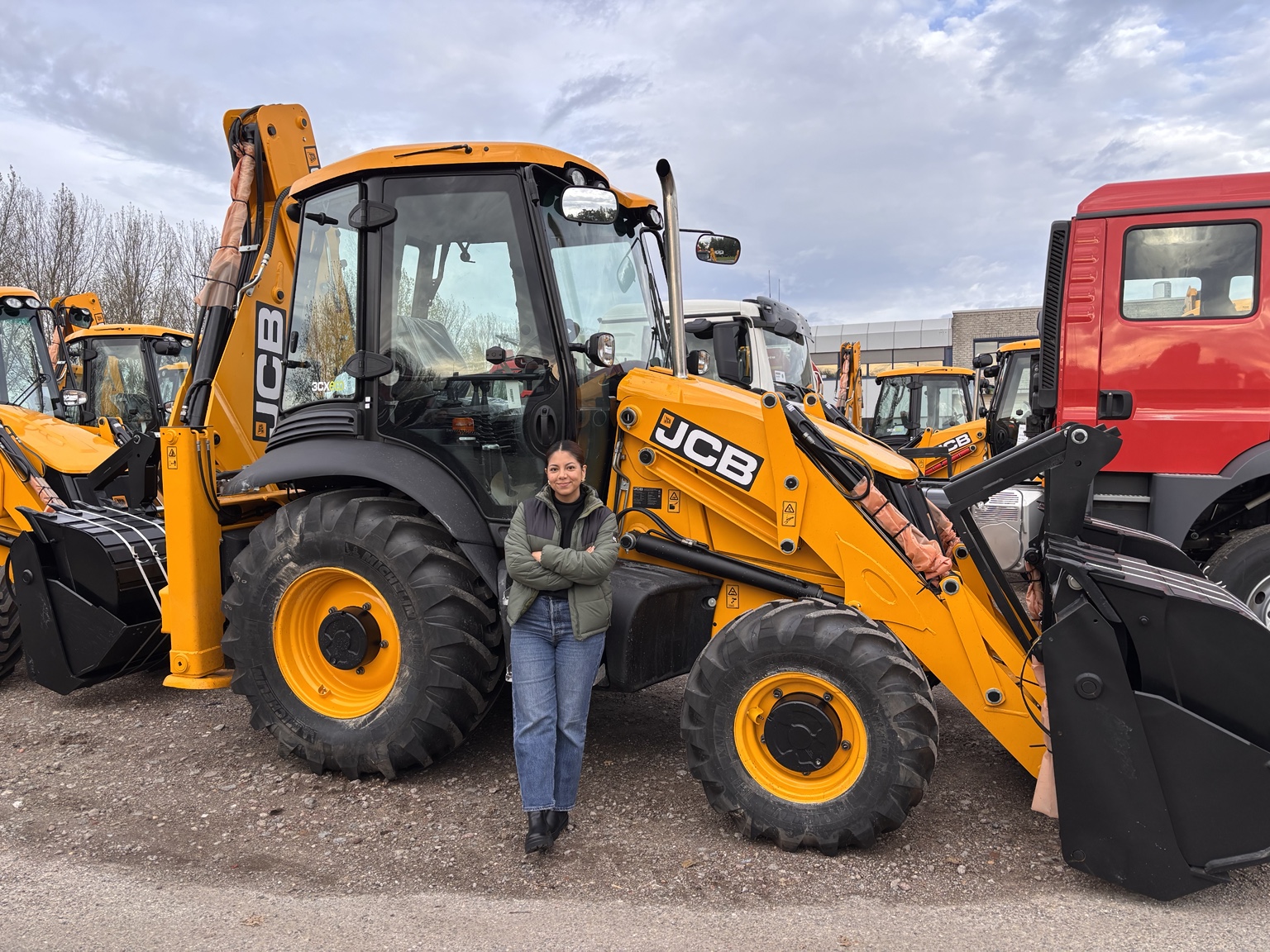 Tamara, founder of The Inspectors, with a JCB vehicle